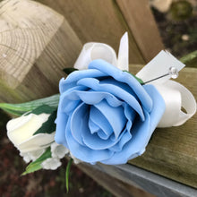 An artificial wedding bouquet of blue and ivory flowers