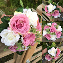 A wedding bouquet featuring silk white and dusky pink roses & foliage