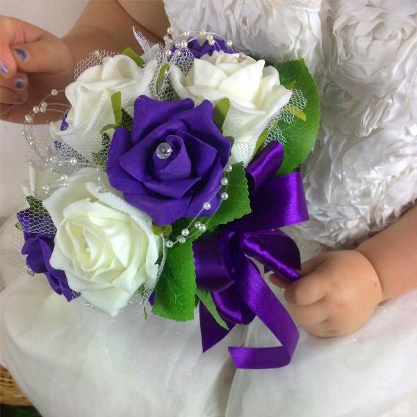 flower girl holding a bouquet of purple and ivory foam roses