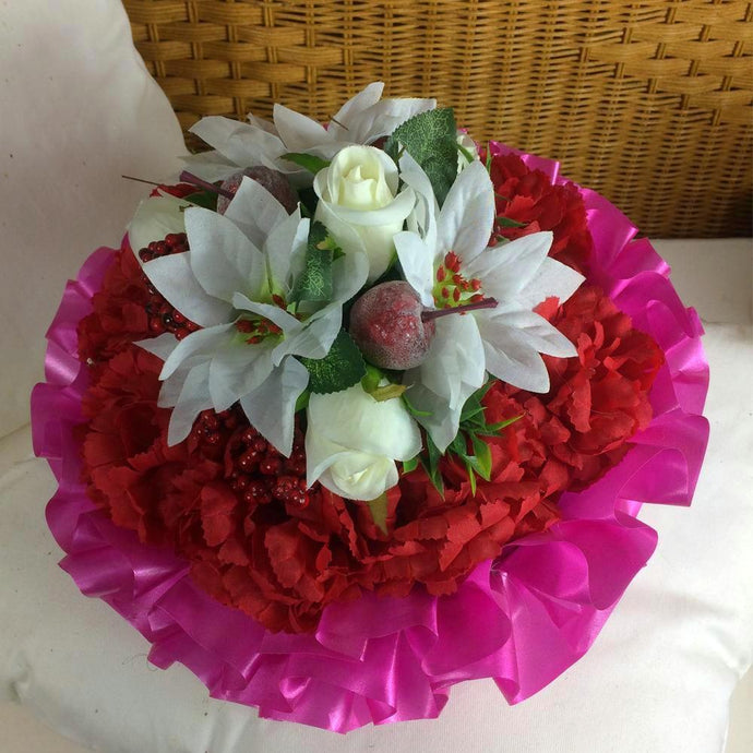 a christmas based posy of poinsettia roses and carnations