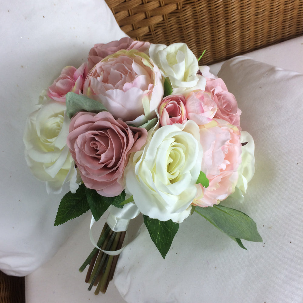 A brides bouquet of pale pink and ivory silk roses & peony flowers ...