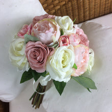 A brides bouquet of pale pink and ivory silk roses & peony flowers