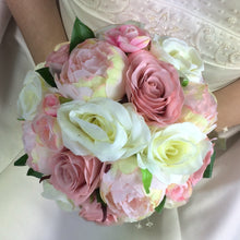a bridal bouquet of dusky pink and ivory flowers