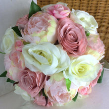 a brides bouquet of artificial silk roses and peonies
