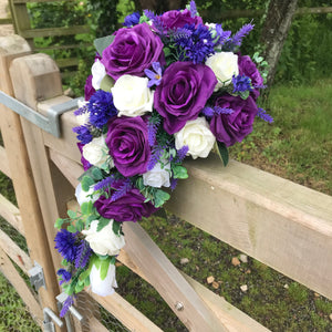 A teardrop bouquet collection of ivory and purple flowers