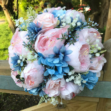 A bouquet of pale pink and blue flowers
