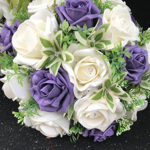 A wedding bouquet of artificial ivory and purple roses