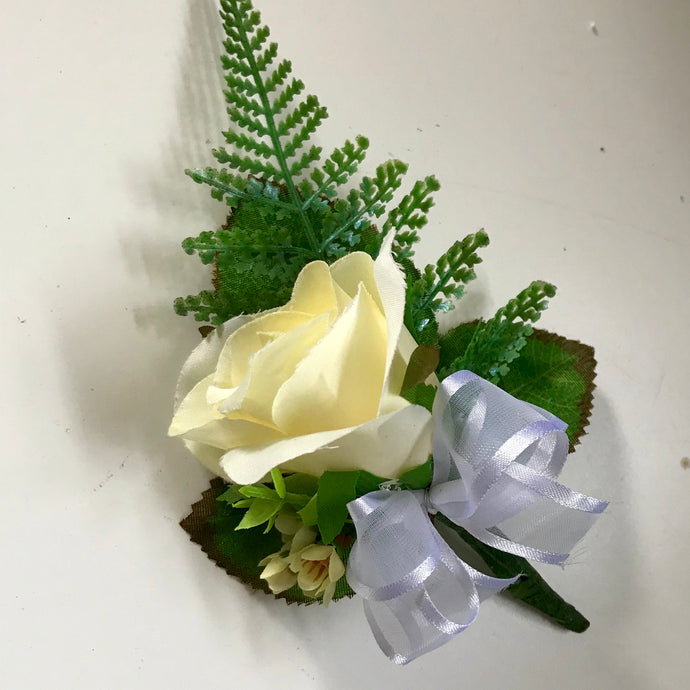 an artificial lemon rose buttonhole