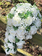 A teardrop bouquet collection of artificial ivory foam roses and gysophila