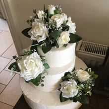 A collection of ivory rose cake decorations