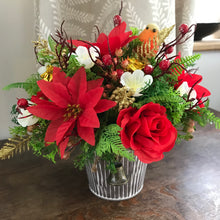 A Christmas artificial red and gold flower arrangement