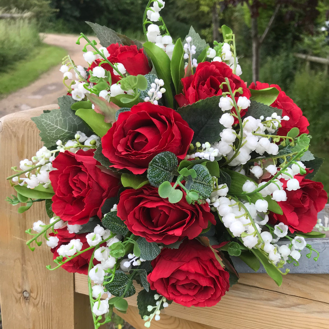 red roses and white lily of the valley bouquet