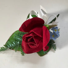 An artificial wedding bouquet collection of red roses, forget me nots and sunflowers