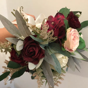 A bridal bouquet of artificial roses and hydrangea