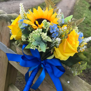 a brides bouquet of sunflowers roses and blue forget-me-nots