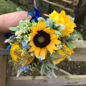 a brides bouquet of sunflowers roses and blue forget-me-nots