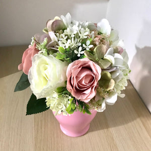 A wedding bouquet of ivory and dusky pink artificial flowers