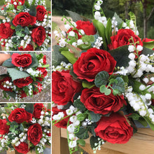 red roses and lily of the valley feature in this wedding bouquet