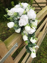 A teardrop bouquet collection of white roses and eucalyptus