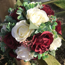 A wedding bouquet of ivory & burgundy silk rose flowers