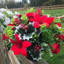 a christmas grave memorial pot with red artificial flower arrangement