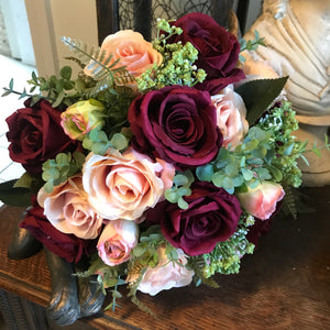 A bridal bouquet of burgundy & blush pink flowers