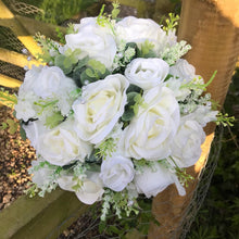 A teardrop bouquet collection of white roses and eucalyptus