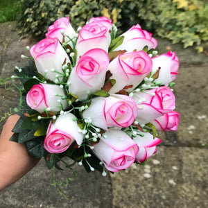 A bridal bouquet of artificial pink edged roses