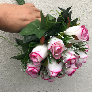 A bridal bouquet of artificial pink edged roses