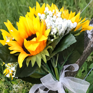A bouquet collection of yellow sunflowers and gysophila