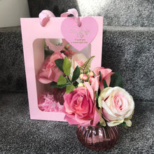 A small posy arrangement of pink silk roses