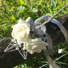 a flower girls silver star wand with ivory roses