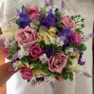 A collection of wedding bouquets featuring artificial purple and pink flowers