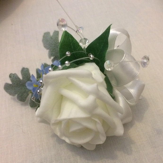 a buttonhole featuring a single fpam rose