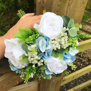 A wedding bouquet collection featuring ivory/white and pale blue flowers