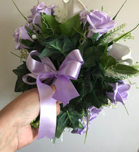A wedding bouquet collection of lilac roses & calla lilies