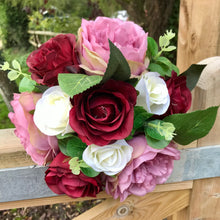 A bouquet of Ivory lilac and burgundy roses