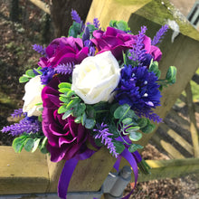 A teardrop bouquet collection of ivory and purple flowers