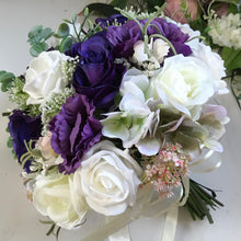 A wedding bouquet of Ivory, white, pink & purple flowers