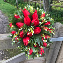 an artificial shower, cascade, teardrop type bouquet featuring red silk tulips