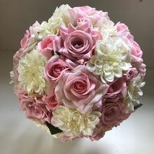 an artificial bridal bouquet of pink roses and ivory dahlia