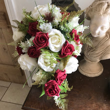 A teardrop bouquet collection of artificial ivory and red roses