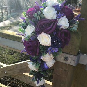 A teardrop bouquet collection of ivory and purple flowers