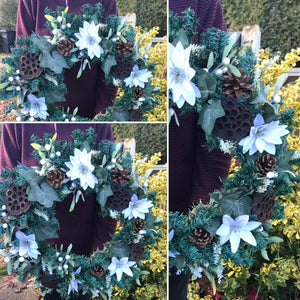 an artificial pine christmas wreath with twigs berries ribbon and cones