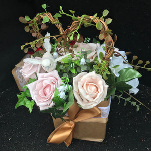 flower arrangement of artificial mocha foam roses in a gift bag
