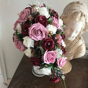 dusky pink burgundy and ivory foam roses feature in this teardrop wedding bouquet