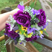 a wedding bouquet collection of purple and yellow daisies & freesia