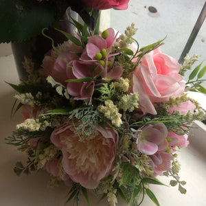 a bouquet of pink roses and peonies