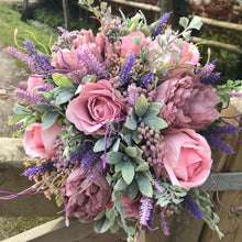 A bridal wedding bouquet of roses and peony flowers