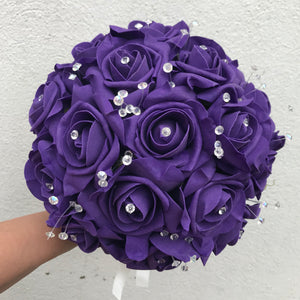 a wedding bouquet of artificial purple foam roses with diamante centres